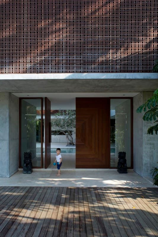 Timber entrance door with a child stepping onto the deck